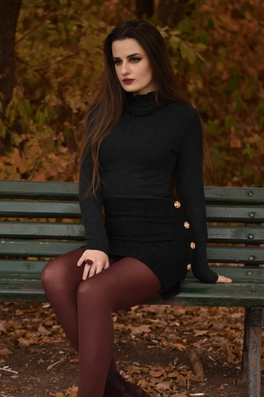the girl is sitting on the bench wearing high heels