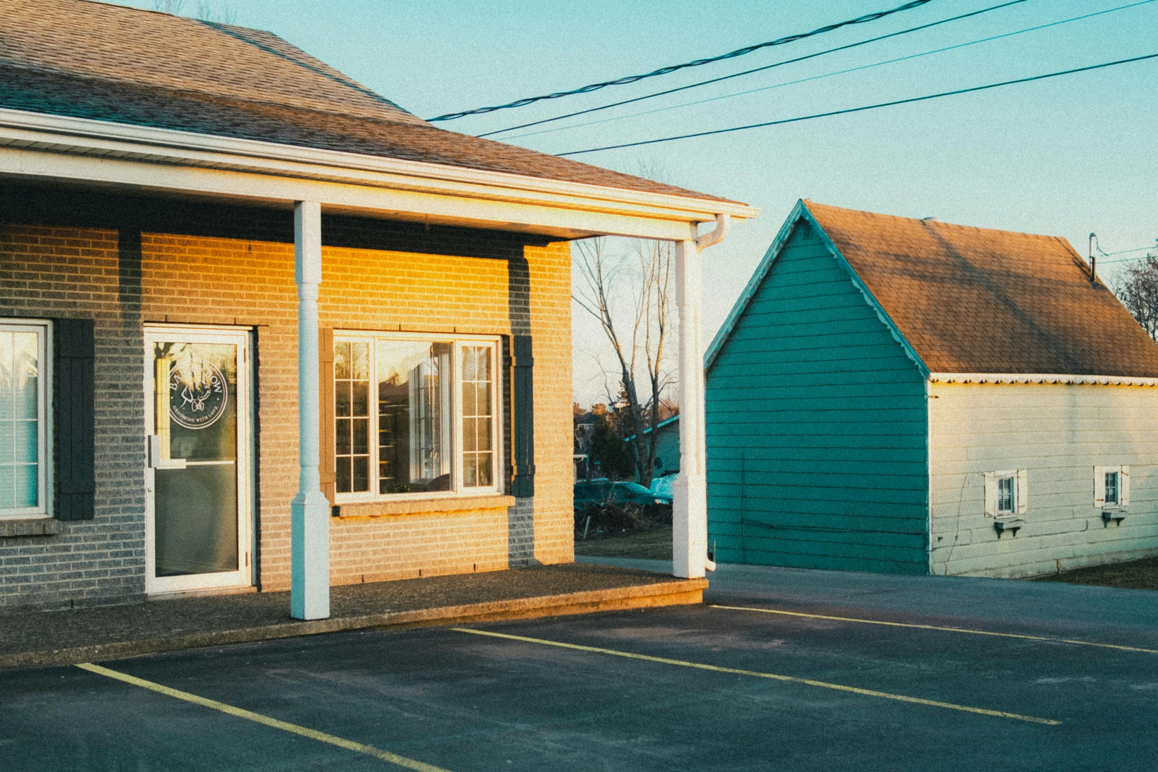 a small blue house in a parking lot