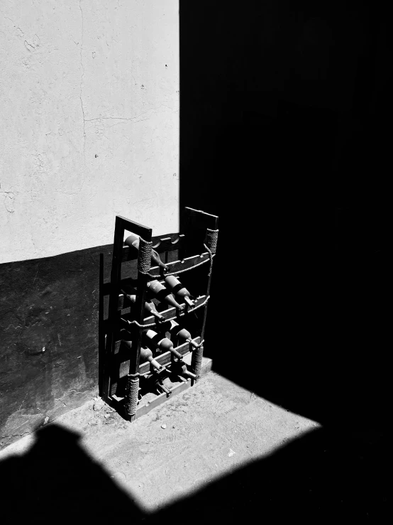 a bottle filled with wine in front of a wall