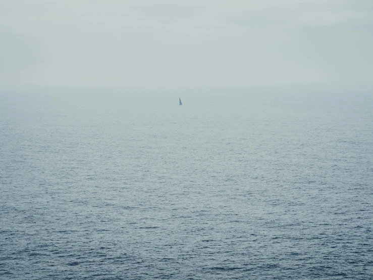 an ocean view with a boat out in the distance