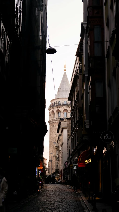 some buildings and one person walking on a cobble stone street