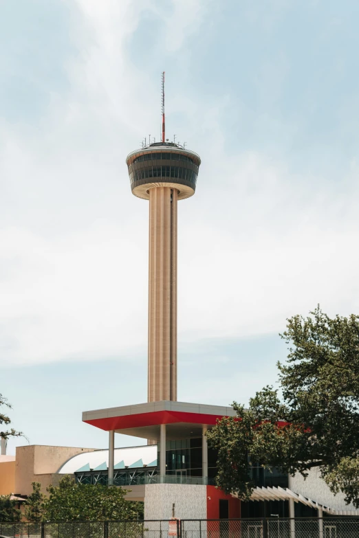 an air traffic control tower next to trees