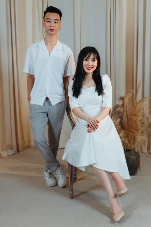 a couple sitting together in chairs posing for the camera