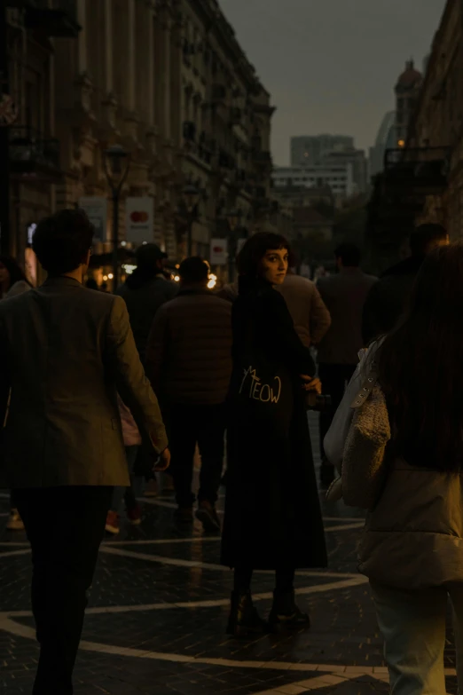 a woman and man standing in the middle of a street