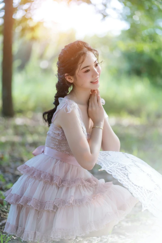 a woman in a pink dress sitting on the ground