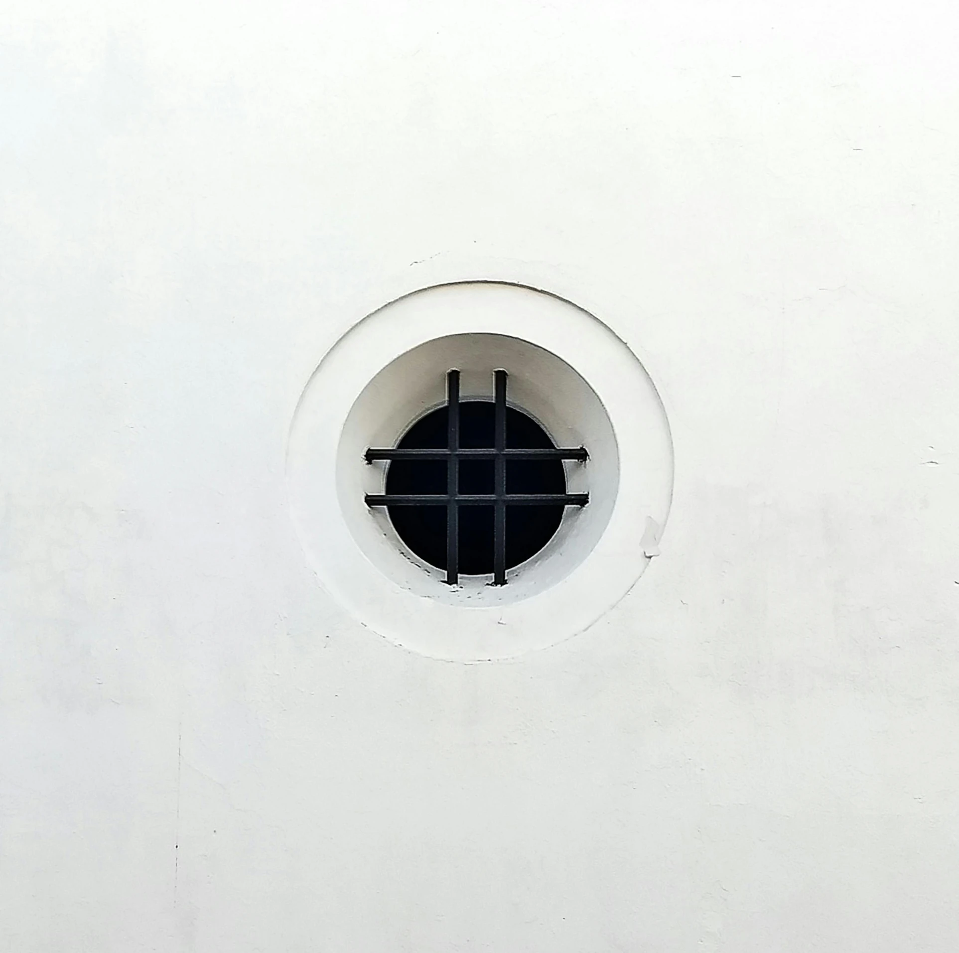 a small white and black window on the side of a building