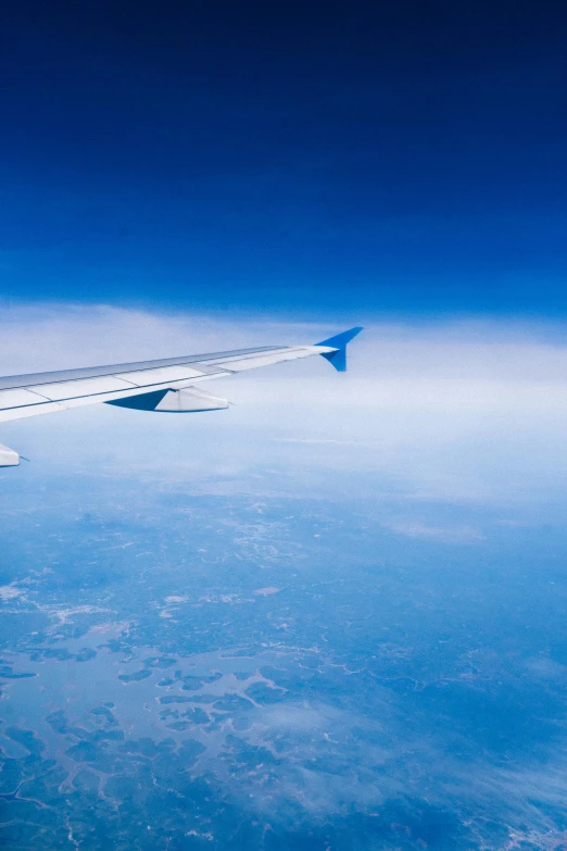 an airplane is flying over the clouds at high altitude