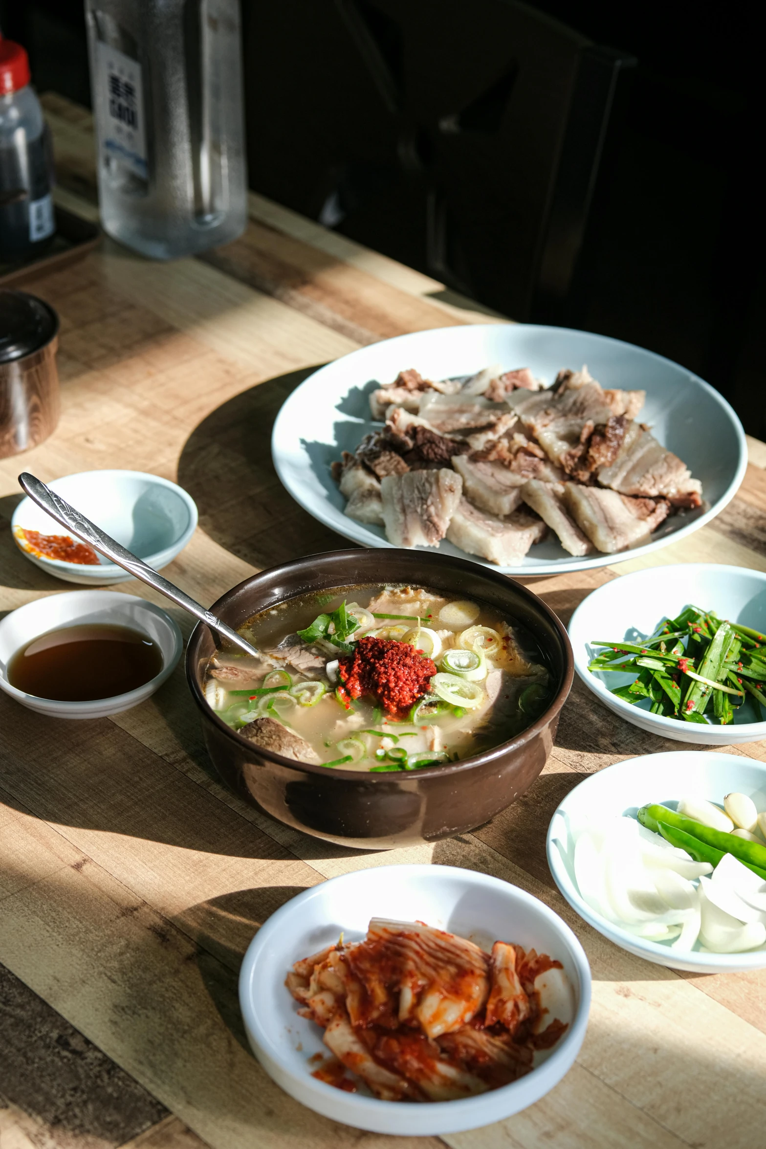 a number of bowls on a table with some food