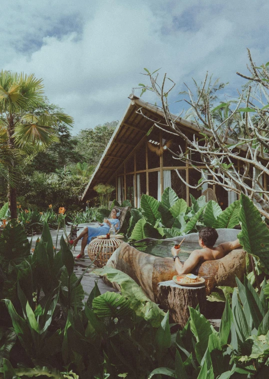 a couple sitting next to each other in front of trees