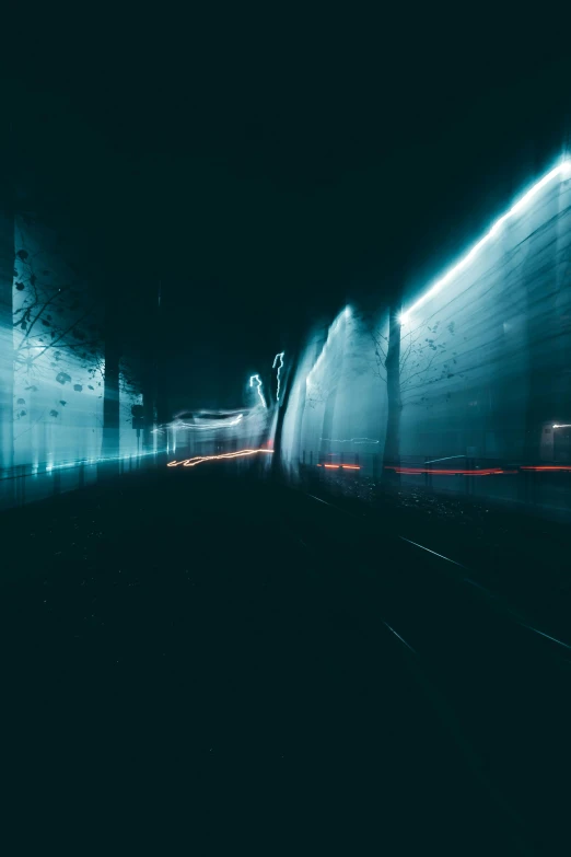 the side of a train on the train track at night