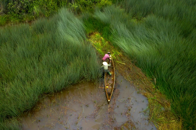 people standing in the rain on their boat