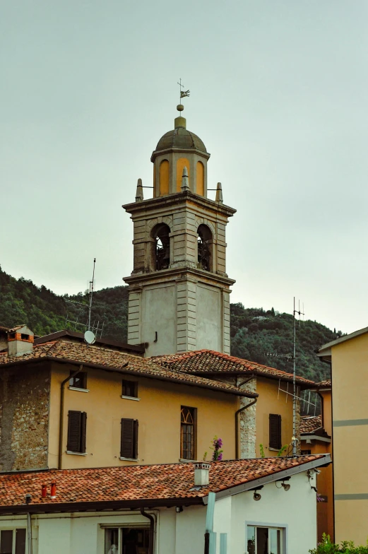 a tall building with a bell tower sitting above a rooftop