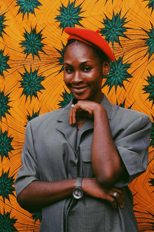 a woman wearing a red hat is standing with her hands on her hip