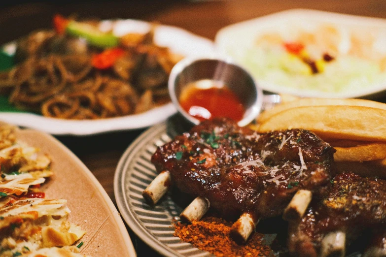 plates full of assorted food that are on a wooden table