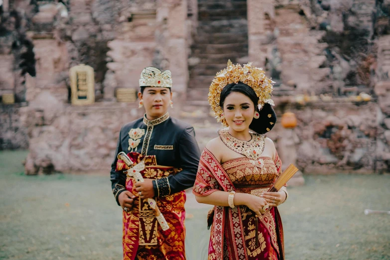 couple posing for an outdoor picture in traditional thai costume