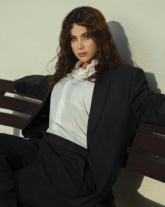 a woman posing for a po while sitting on a bench