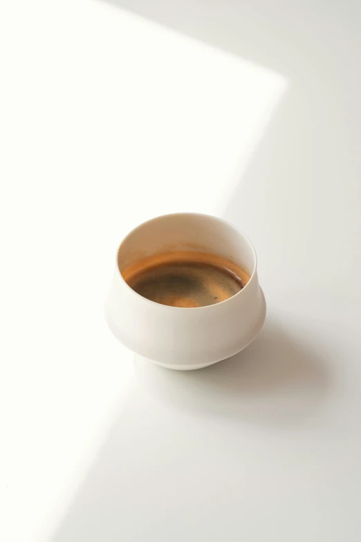 a cup is sitting on the table, with a white background