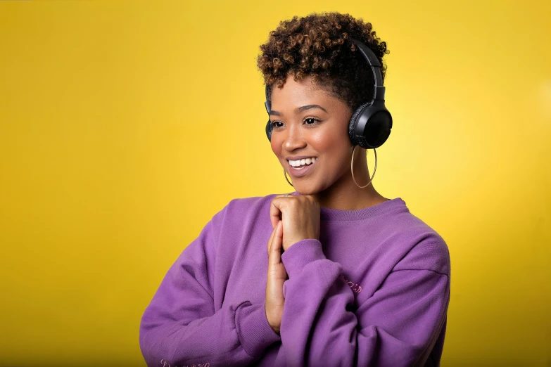 a woman wearing headphones and looking at the camera