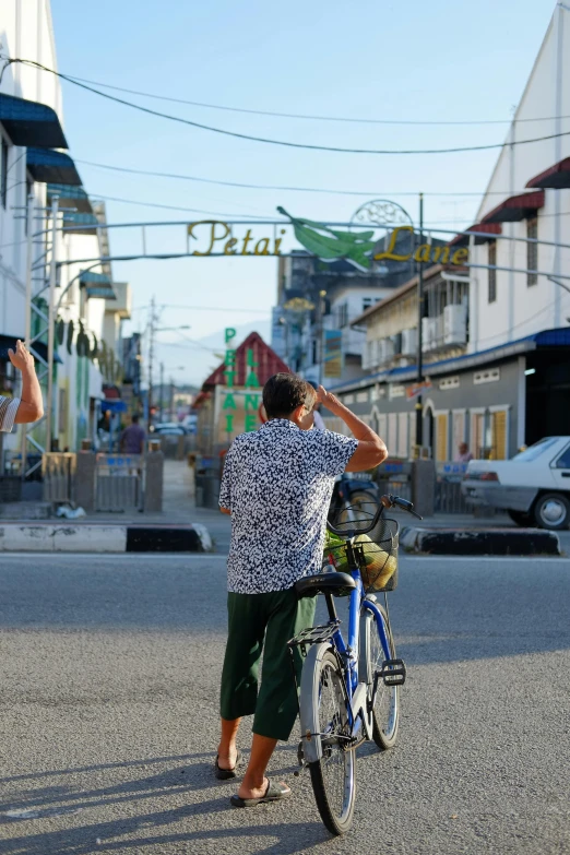 a person that is leaning on a bike