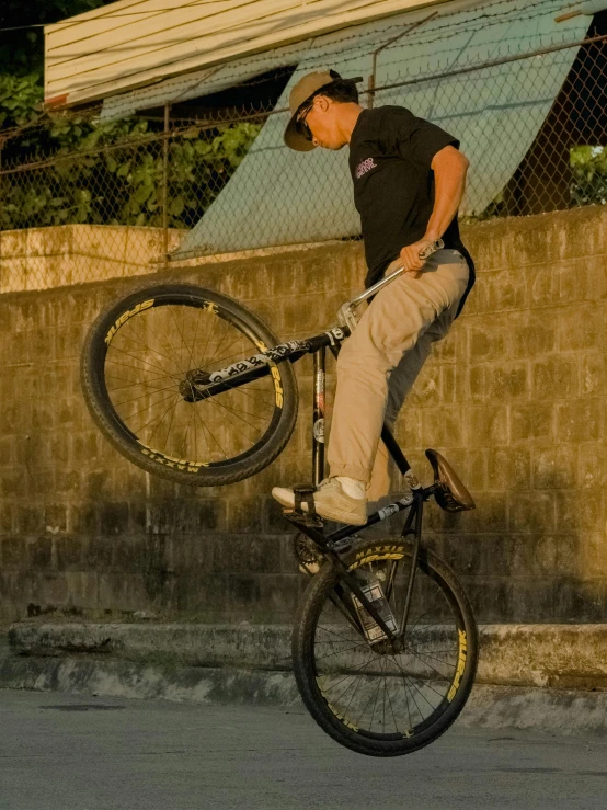 a man doing tricks on his bike with a wheel