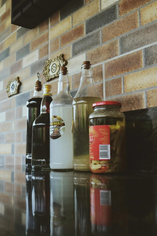 a table topped with four bottles of liquor