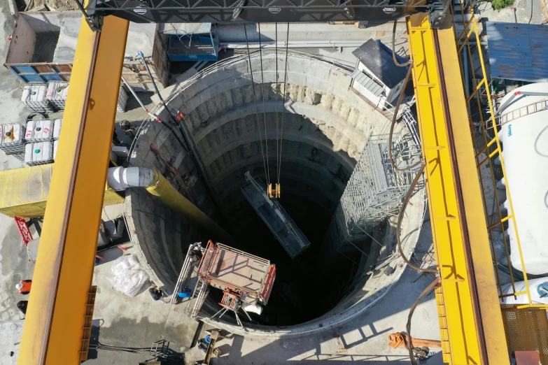 construction equipment is surrounding the large hole