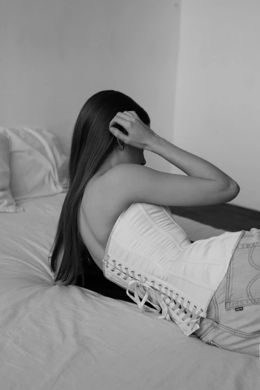 woman laying back on her stomach with her hair in a ponytail