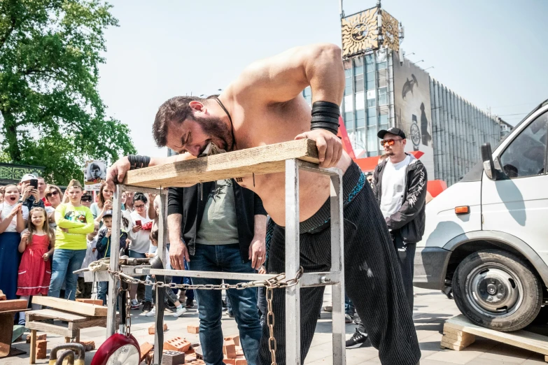 man leaning over on his chair as the rest of a row of people watch