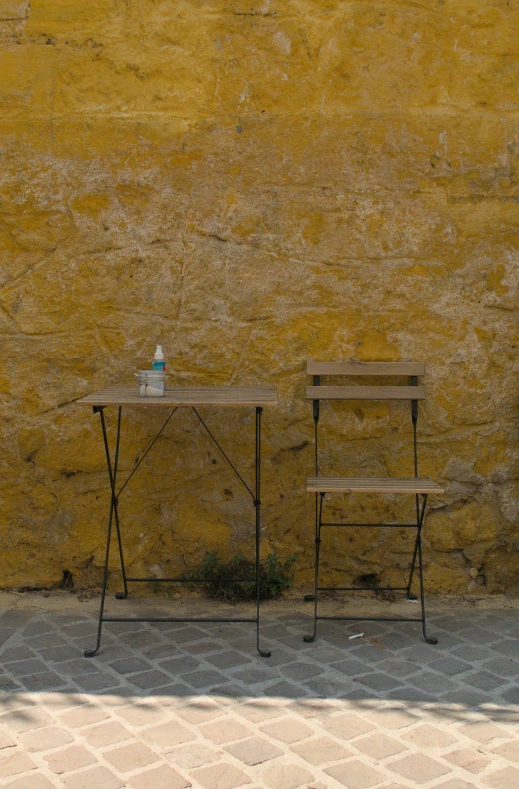 a table on a side walk next to a building