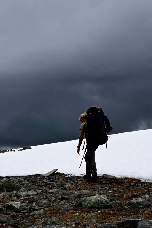 the back end of a hiker as he walks across the snow