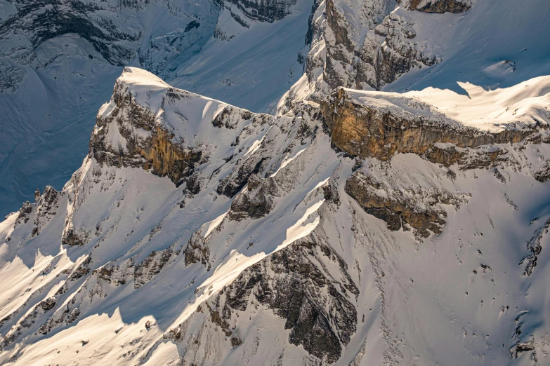 the top of the snowy mountains are covered in snow