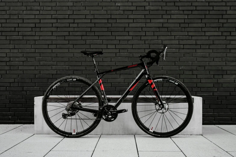 a black and red bike against a black wall