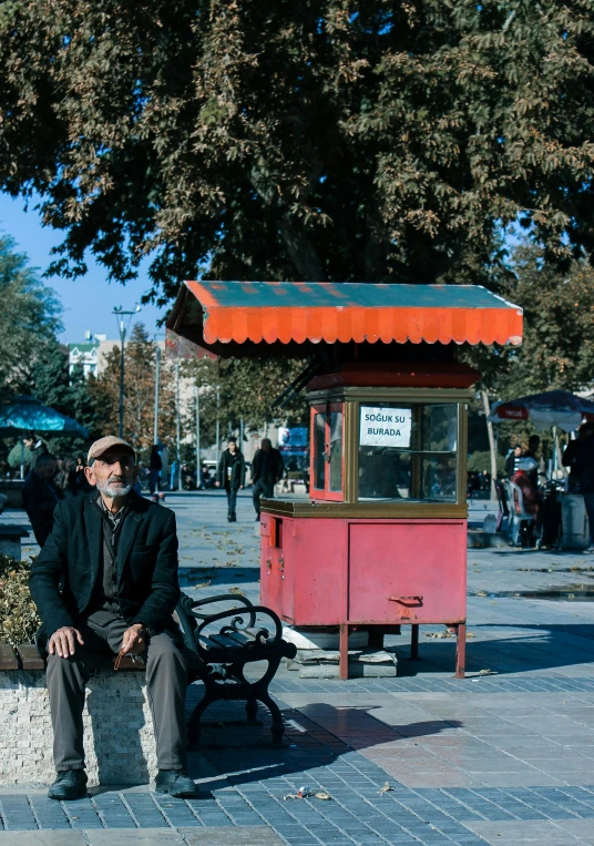 a man sits on a bench in the middle of the street