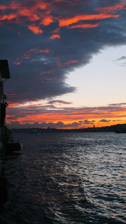 water and houses are shown as the sun sets