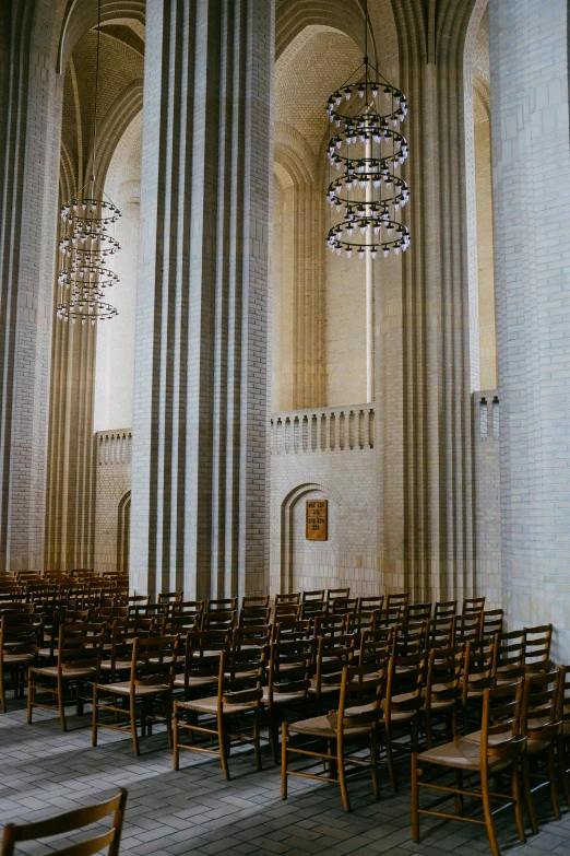 rows of wooden chairs are set up inside a church