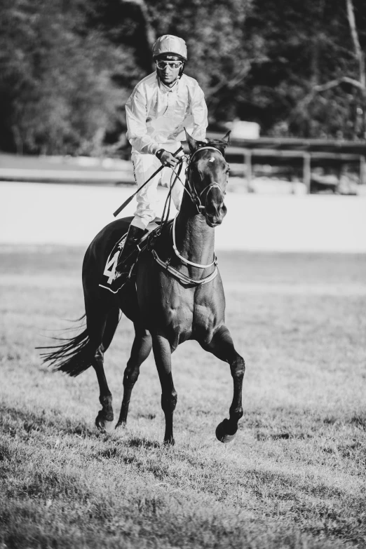 a man riding a horse in an open field