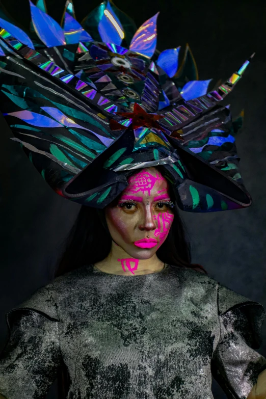 a woman is wearing a hat with feathers