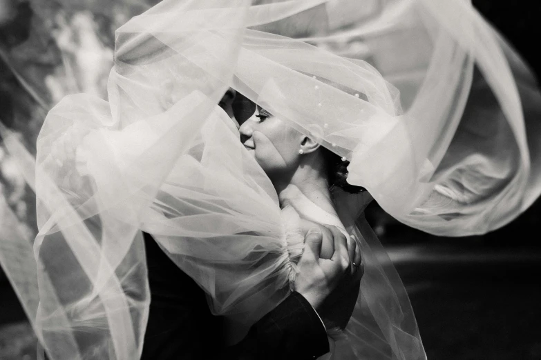 a woman hiding behind the veil of a plastic bag