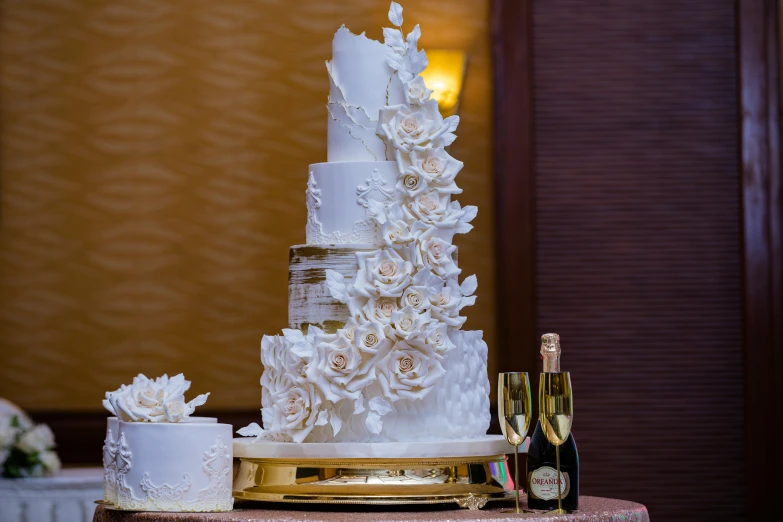 a large white wedding cake is displayed on a table