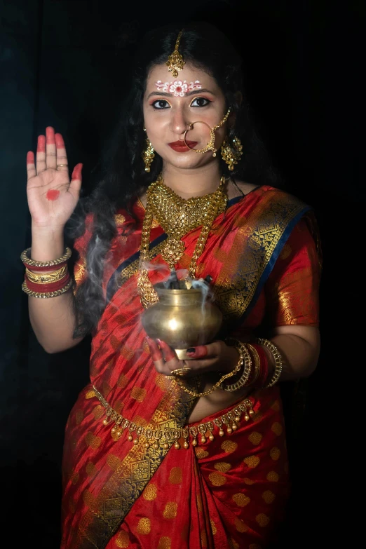 the girl in the indian saree is holding her hand