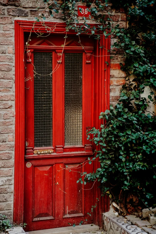 a building has a red door and window in the middle