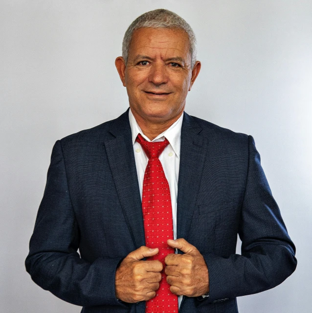 a man is wearing a suit and red tie