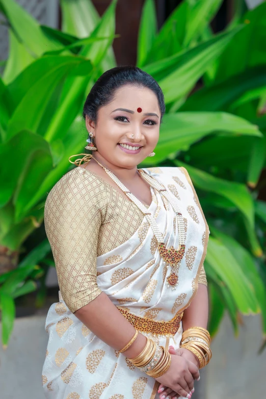 a beautiful young lady in white sari