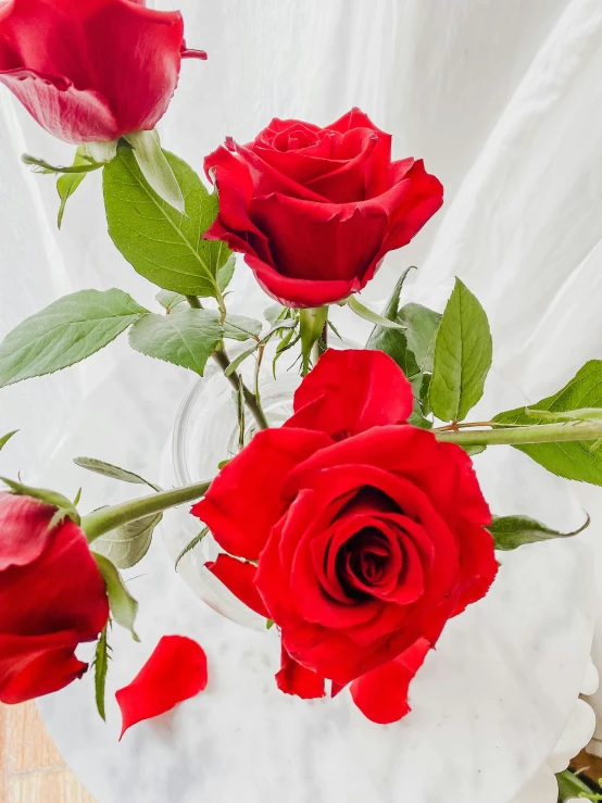 a bunch of red roses in a vase