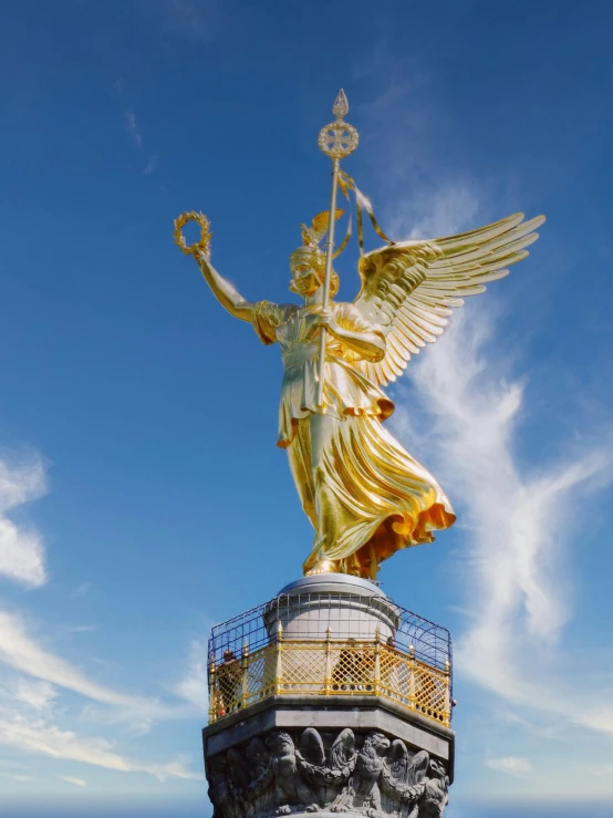 there is a golden statue on the beach