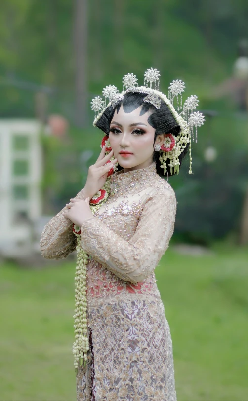 a girl wearing an oriental dress and flowered head piece