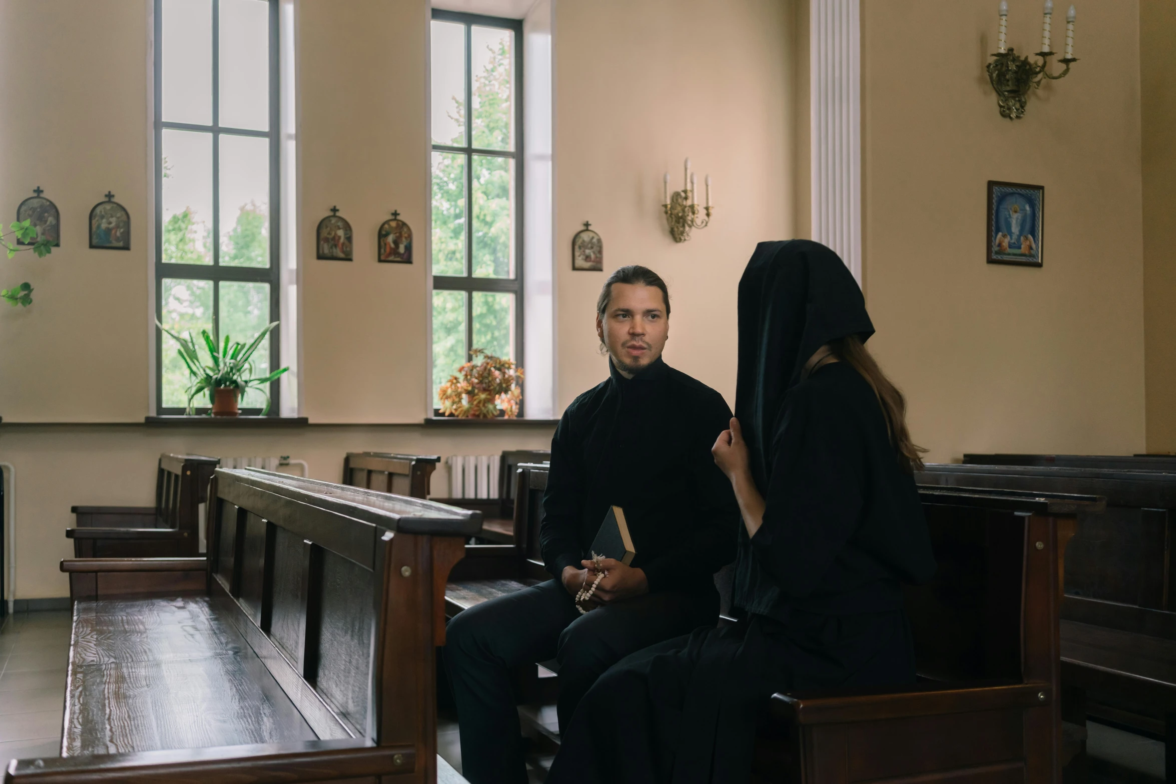 two women sitting down and one woman standing