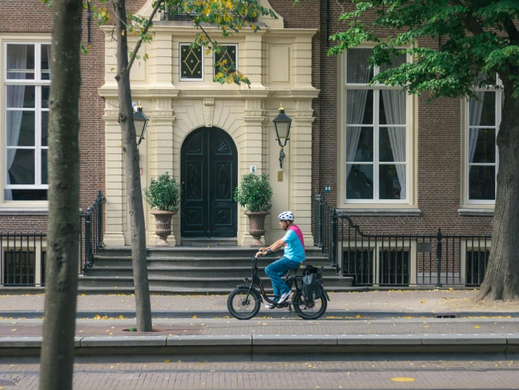 a man riding his bike down the street