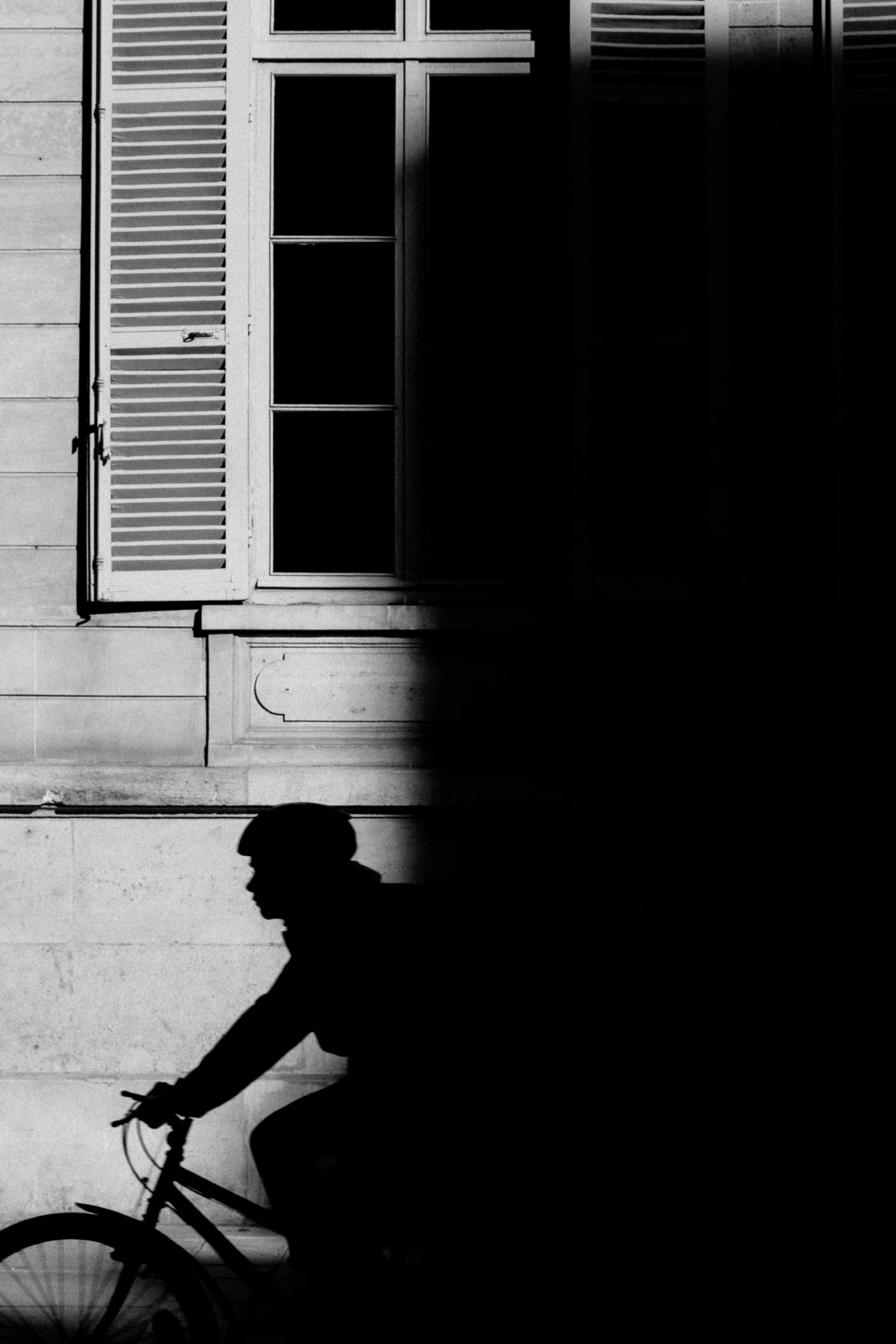 black and white pograph of a person on a bicycle