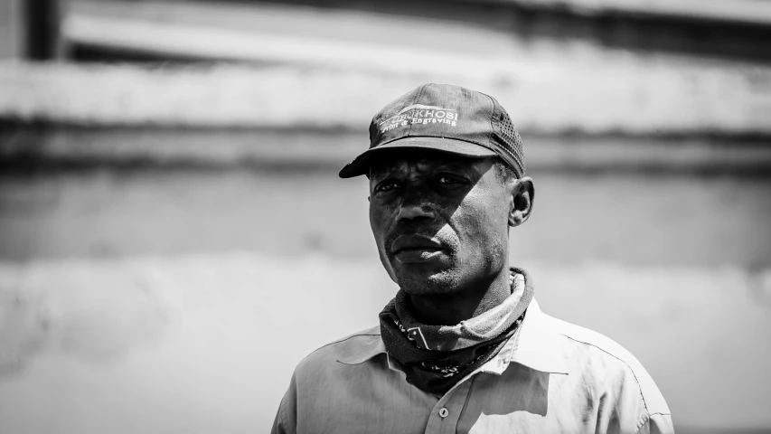 black and white pograph of man wearing a cap